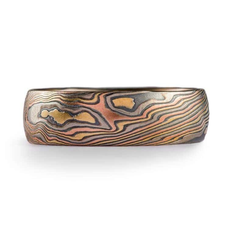 high contrast mokume gane ring with oxidized silver, yellow gold, red gold and palladium for a mixed metal and organic look