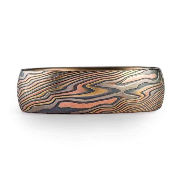 high contrast mokume gane ring with oxidized silver, yellow gold, red gold and palladium for a mixed metal and organic look