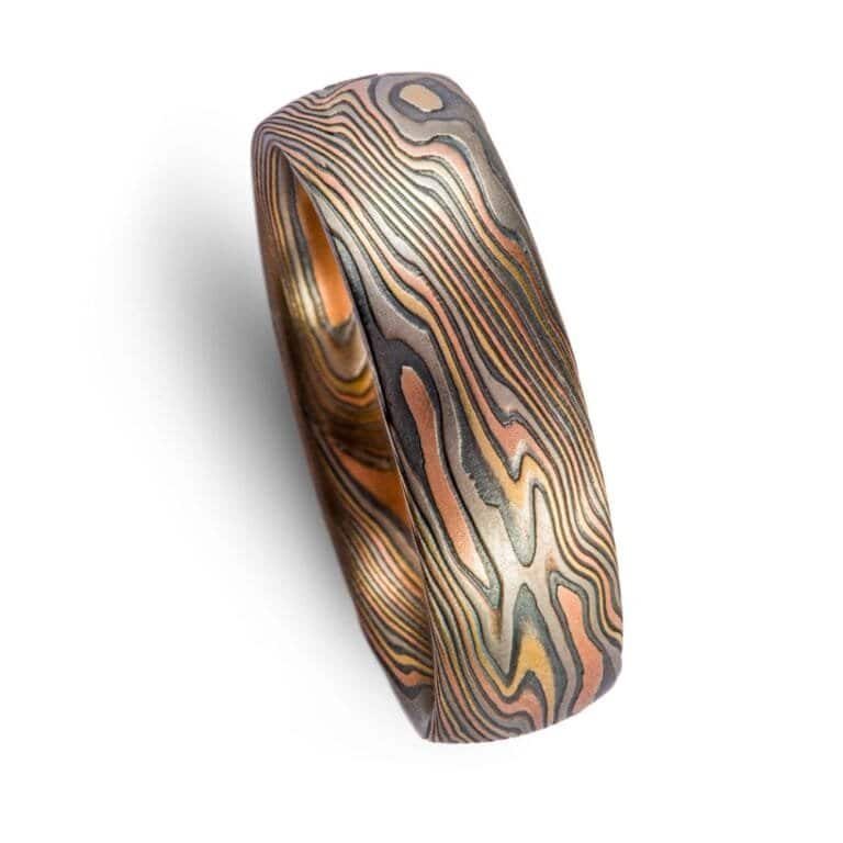 high contrast mokume gane ring with oxidized silver, yellow gold, red gold and palladium for a mixed metal and organic look