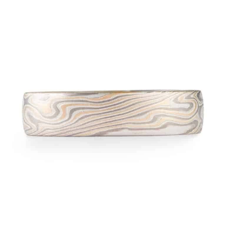 twisted pattern mokume gane ring with smooth surface, made with yellow gold, palladium and sterling silver