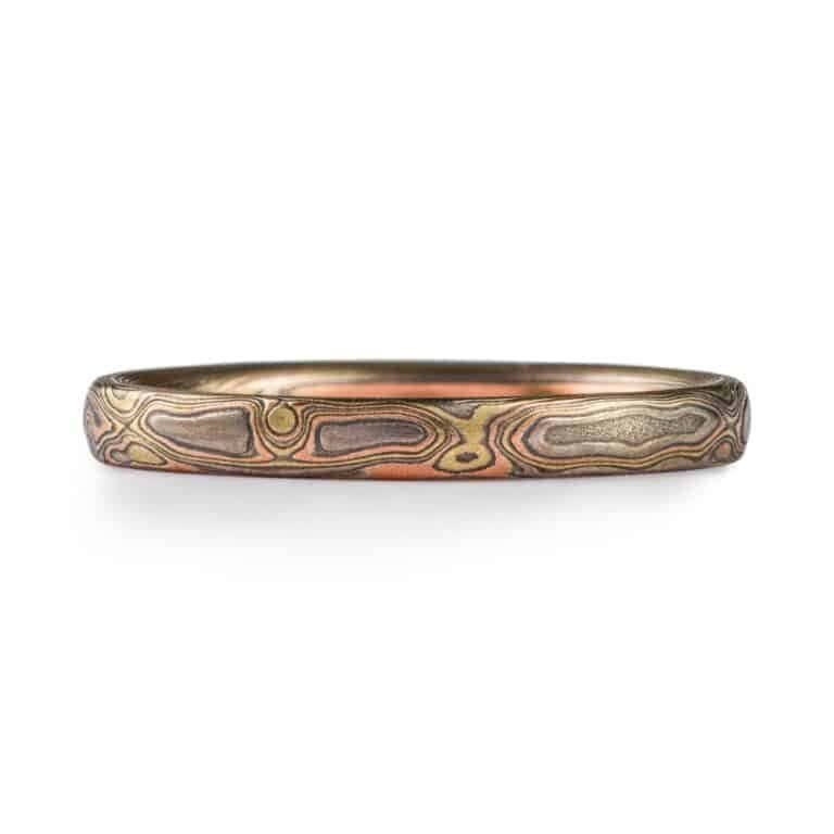 narrow mokume gane band in mixed metals with woodgrain style pattern