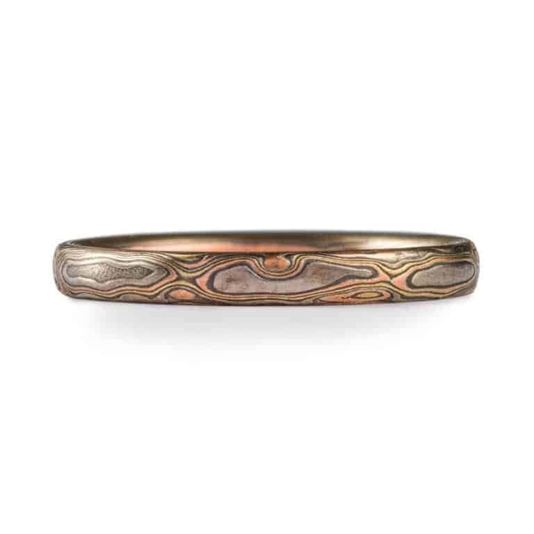 narrow mokume gane band in mixed metals with woodgrain style pattern