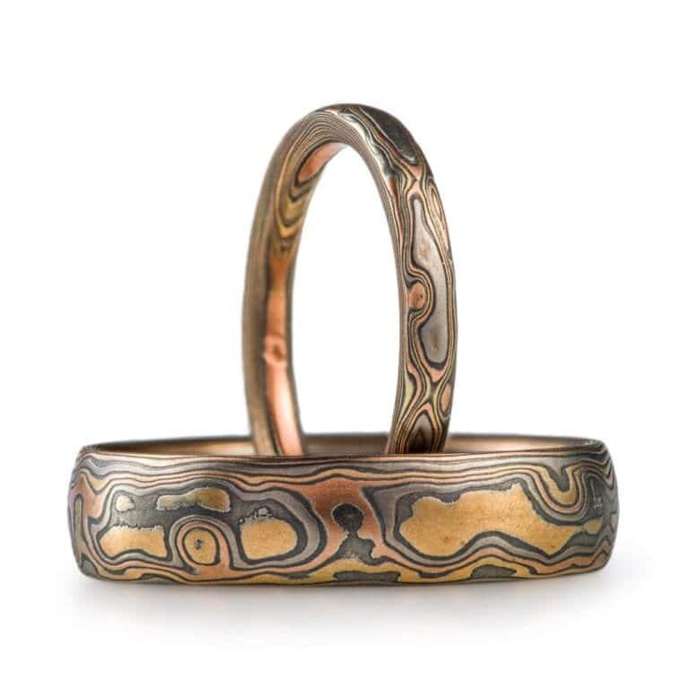 set of two matching mokume gane woodgrain patterned rings, one narrow and one wider