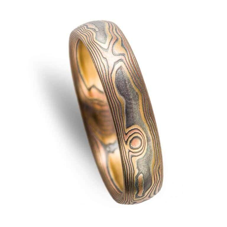 woodgrain pattern ring made with layered metals, red and yellow gold, palladium and oxidized silver