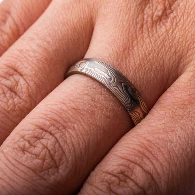 woodgrain pattern ring made with layered metals, red and yellow gold, palladium and oxidized silver