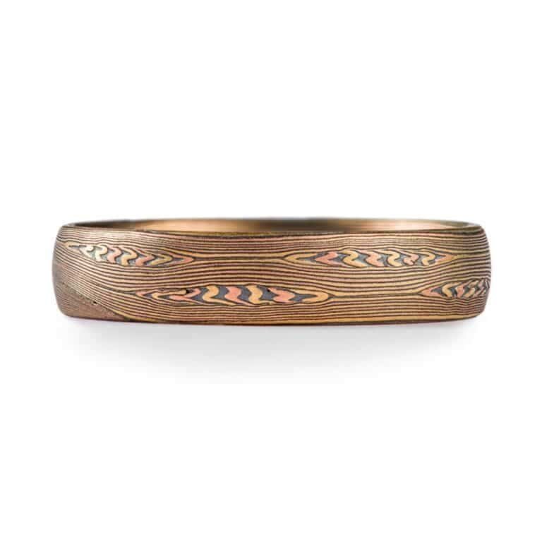 contemporary edges ring in linear pattern with red gold, silver and yellow gold. heirloom quality