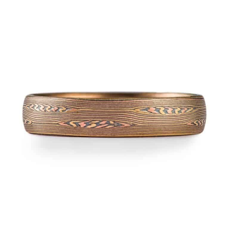 contemporary edges ring in linear pattern with red gold, silver and yellow gold. heirloom quality