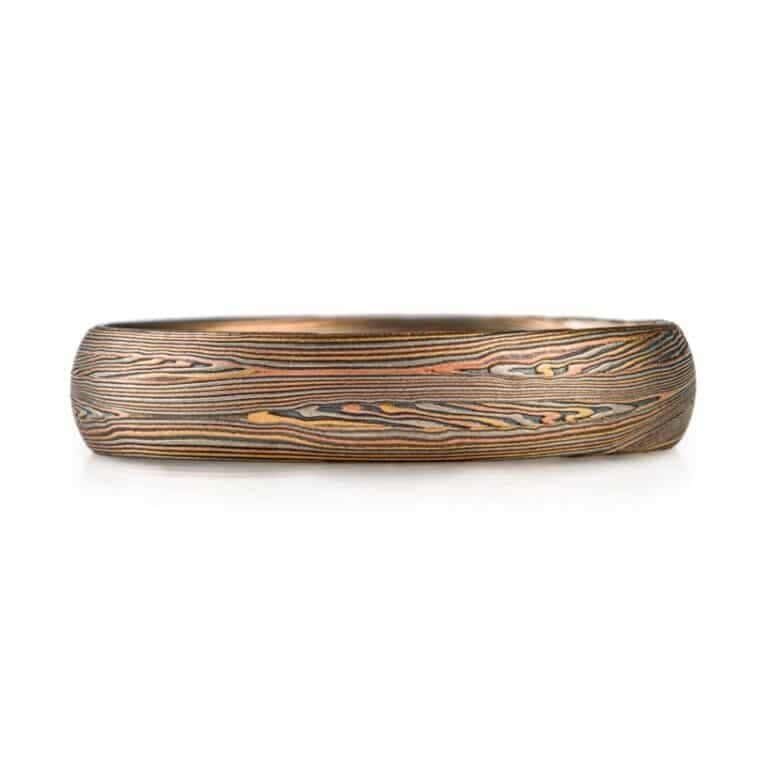 mokume gane narrow band in red gold yellow gold palladium and oxidized silver palette, very linear and detailed pattern