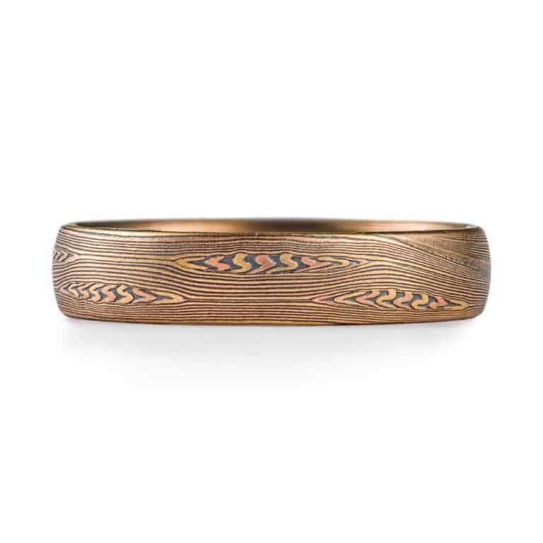 contemporary edges ring in linear pattern with red gold, silver and yellow gold. heirloom quality