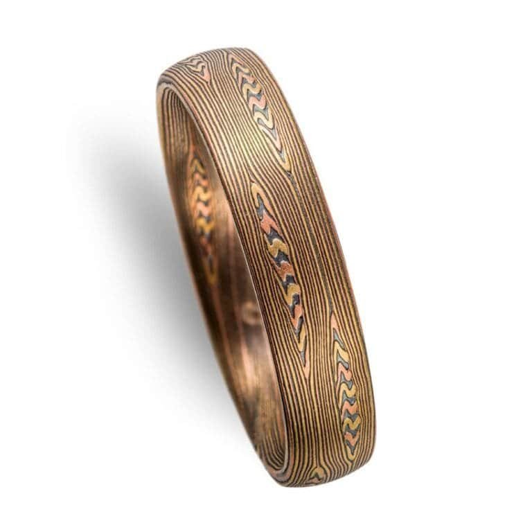 contemporary edges ring in linear pattern with red gold, silver and yellow gold. heirloom quality