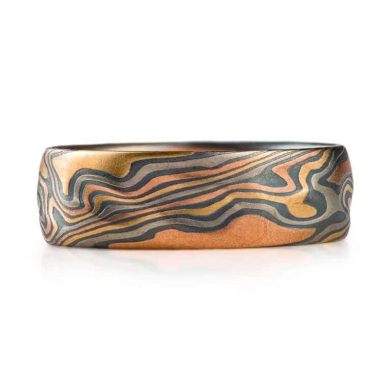 wide mokume gane patterned band, made with multiple different metals in a twist pattern