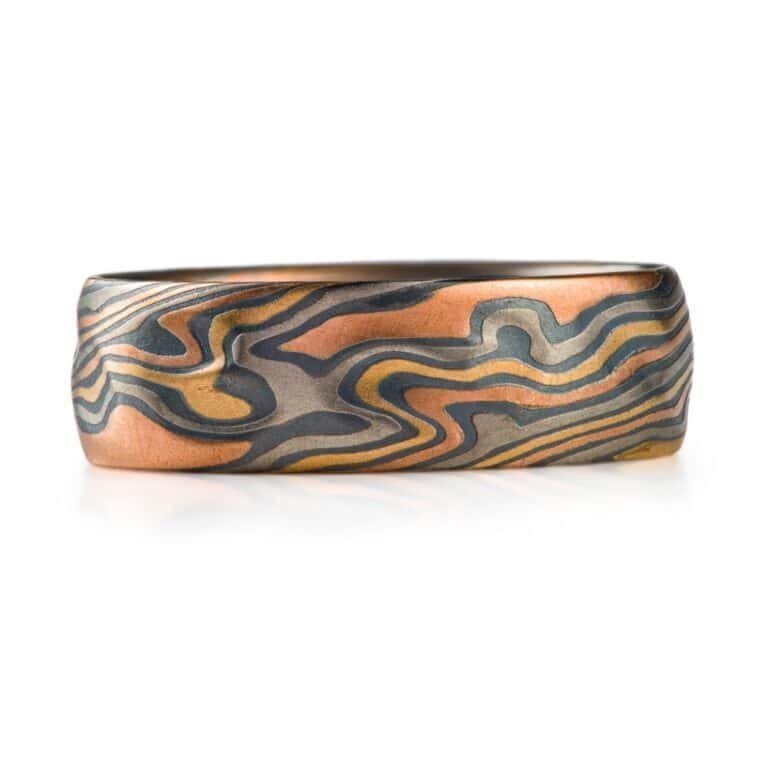 wide mokume gane patterned band, made with multiple different metals in a twist pattern