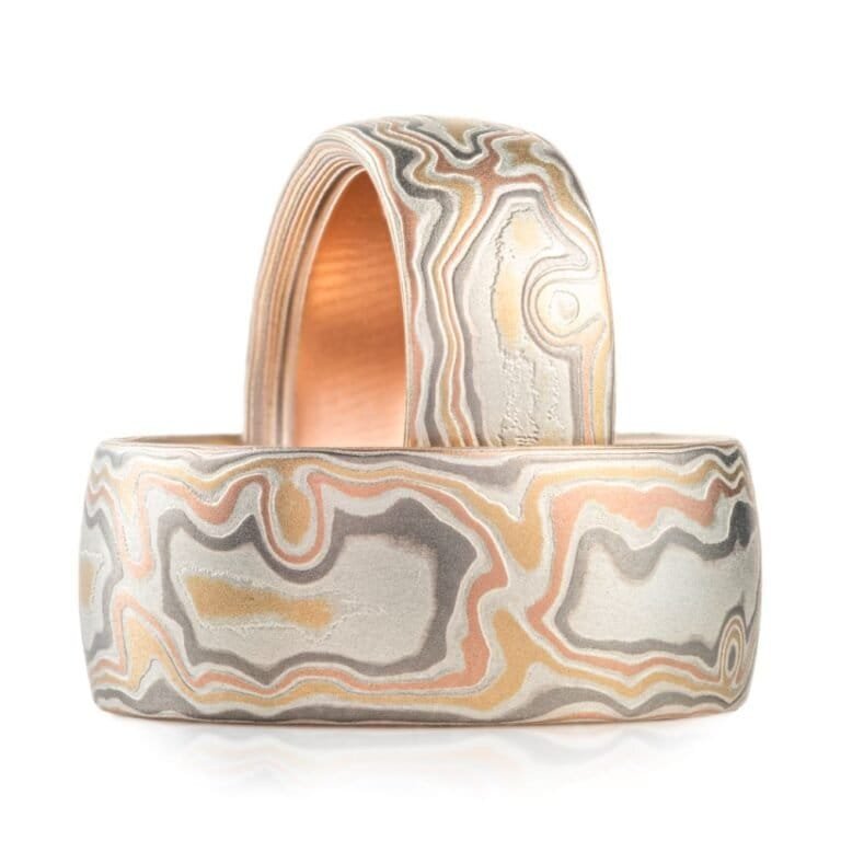 set of matching mokume gane rings, both in a woodgrain pattern, both wide