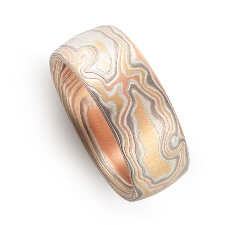 wide woodgrain style patterned ring in a light color palette, slightly domed profile