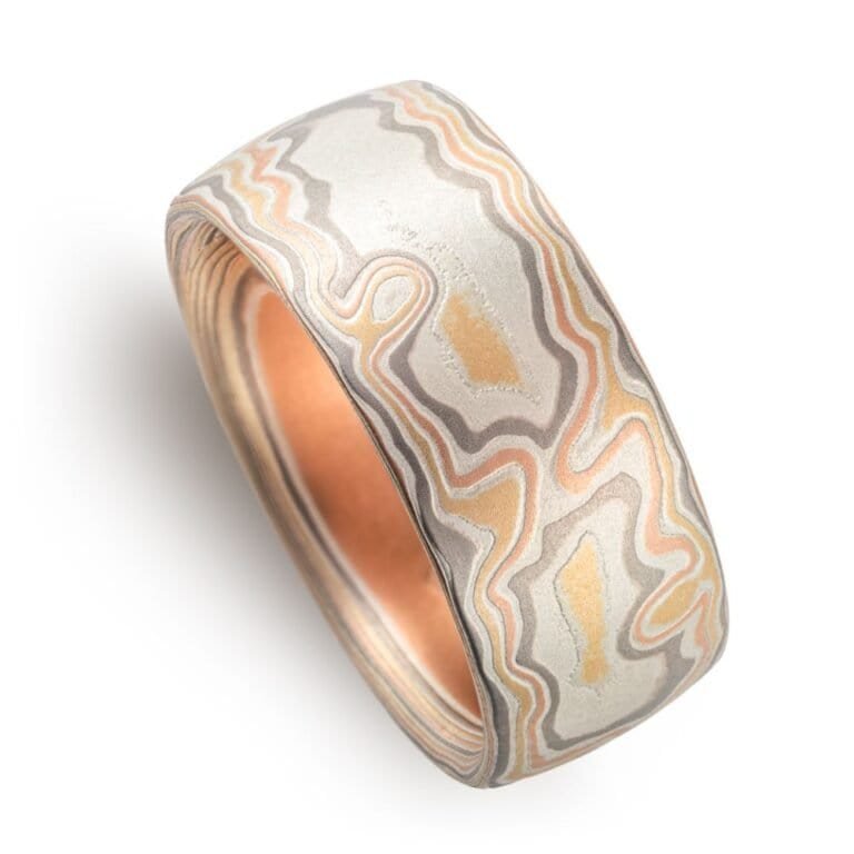 wide woodgrain style patterned ring in a light color palette, slightly domed profile