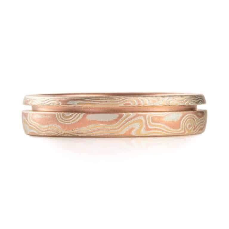 red gold mokume gane ring with a unique inset line, a narrow channel carved into the ring going all the way around, not quite centered, off to one edge