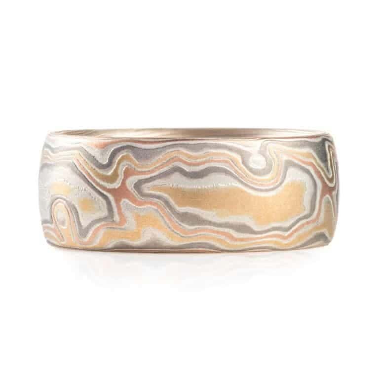 wide woodgrain style patterned ring in a light color palette, slightly domed profile