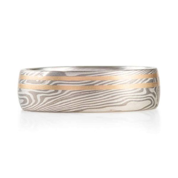 mokume gane silvery ring with two yellow gold lines running perfectly parallel around the band