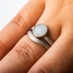 Mokume gane engagement ring with bezel set moonstone bezel setting. 14K white gold palladium sterling silver, with a matching contoured band that curves around the stone