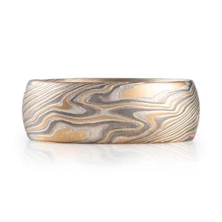 wide twisted pattern ring with textured finish, made with yellow gold, palladium and silver