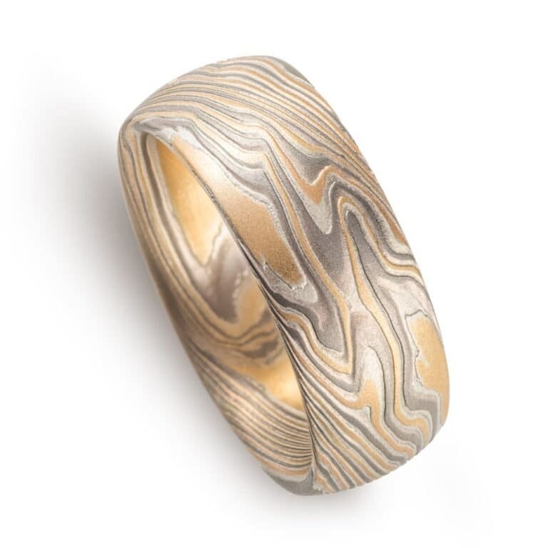 wide twisted pattern ring with textured finish, made with yellow gold, palladium and silver