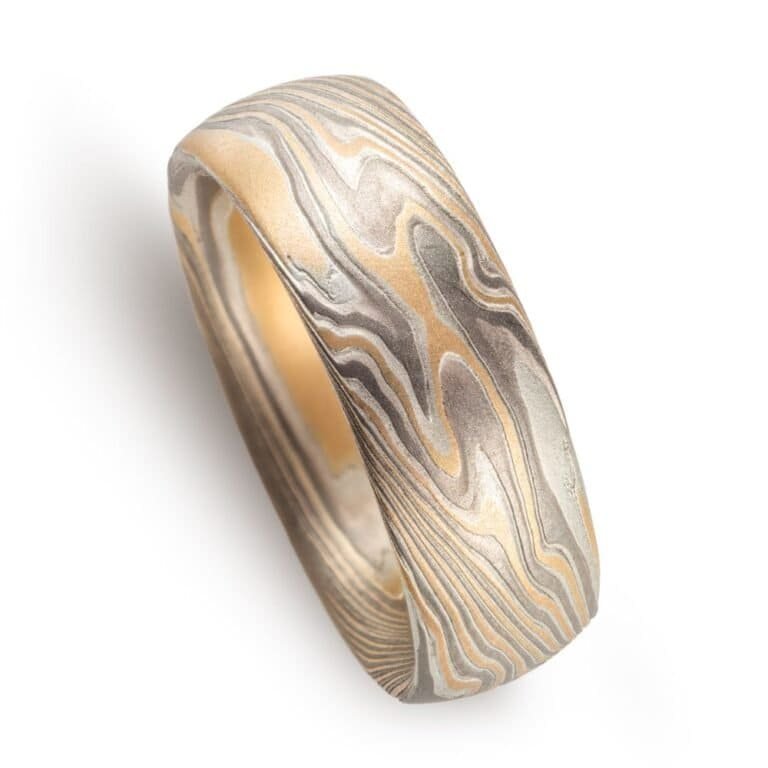 wide twisted pattern ring with textured finish, made with yellow gold, palladium and silver