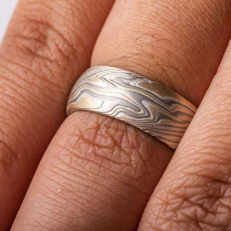 wide twisted pattern ring with textured finish, made with yellow gold, palladium and silver