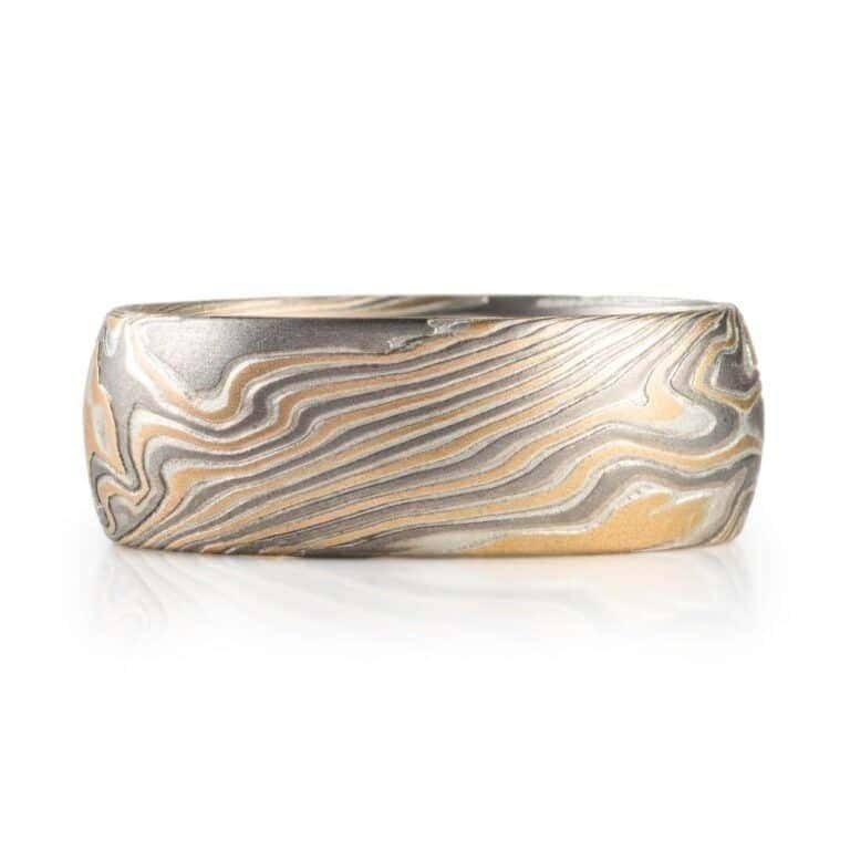 wide twisted pattern ring with textured finish, made with yellow gold, palladium and silver