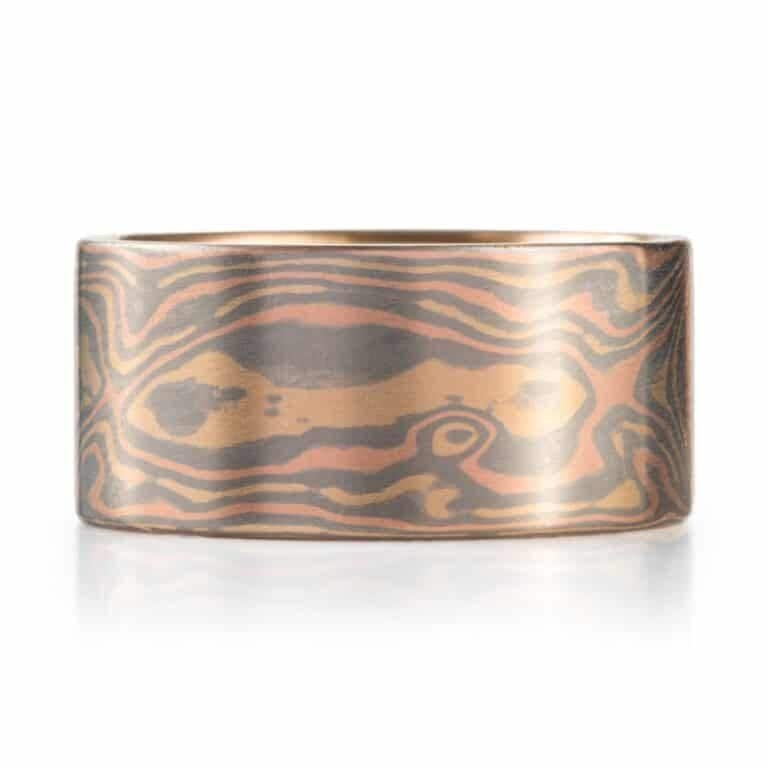 extra wide mokume gane ring made in all gold with a flat profile and smooth surface, patterned in woodgrain style