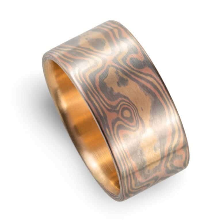 extra wide mokume gane ring made in all gold with a flat profile and smooth surface, patterned in woodgrain style