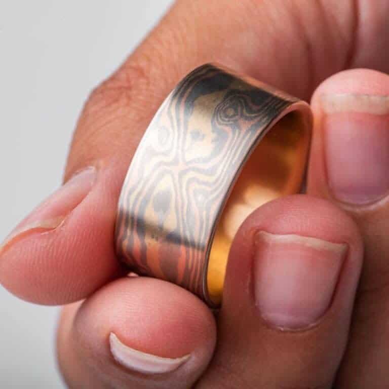 extra wide mokume gane ring made in all gold with a flat profile and smooth surface, patterned in woodgrain style