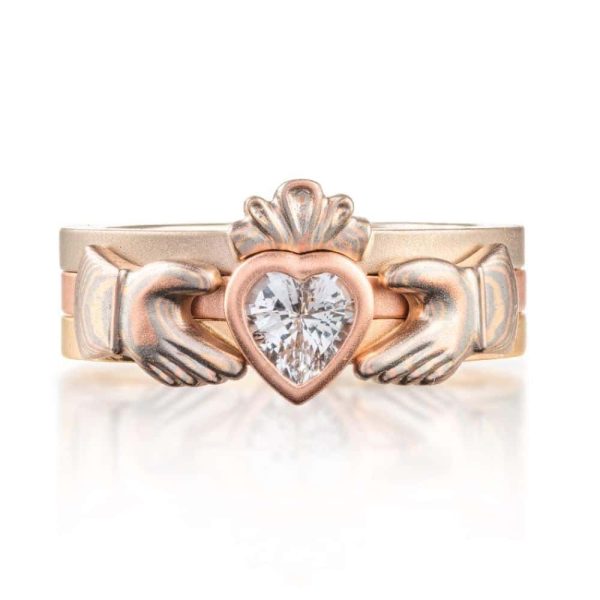 custom made three part claddagh ring, with mokume hands holding a white sapphire heart shaped stone, with a mokume crown on top of the stone