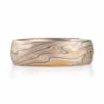 textured twist pattern ring, with a carved surface like rolling waves on the surface of water, overall light looking, made with layers of red and yellow gold, palladium and silver