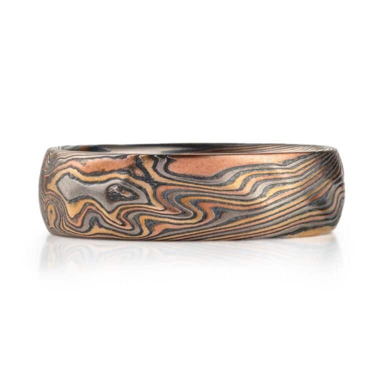 mokume twist pattern ring, made with red and yellow gold, palladium and oxidized silver, with some added texture