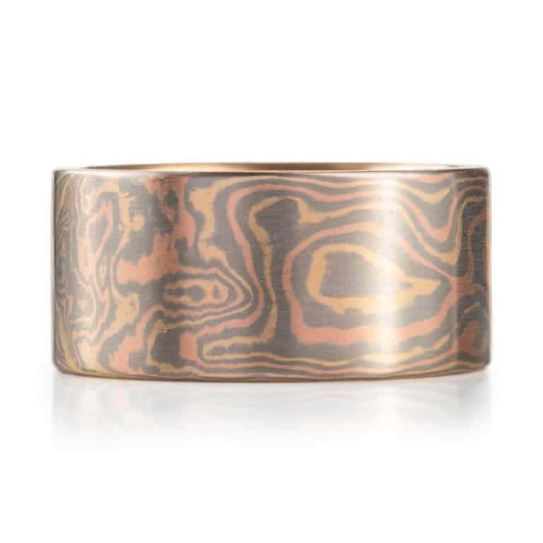 extra wide mokume gane ring made in all gold with a flat profile and smooth surface, patterned in woodgrain style