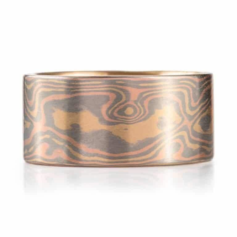 extra wide mokume gane ring made in all gold with a flat profile and smooth surface, patterned in woodgrain style