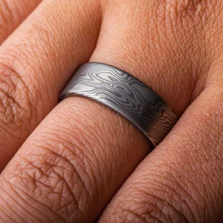 wide flat profiled ring, made in mokume twist pattern with alternating layers of palladium and oxidized silver