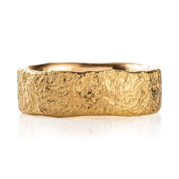 yellow gold band with a stone like texture all over