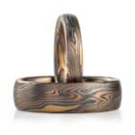 set of matching rings, made in same mokume gane pattern, one ring narrow and one ring wider