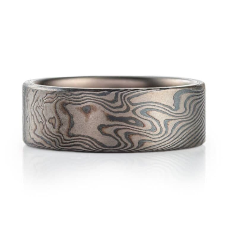 wide flat profiled ring, made in mokume twist pattern with alternating layers of palladium and oxidized silver