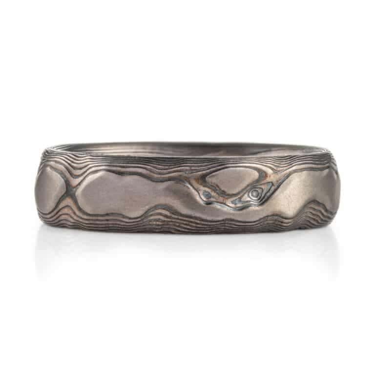 textured mokume ring made to look like rock formation, overall dark gray palette