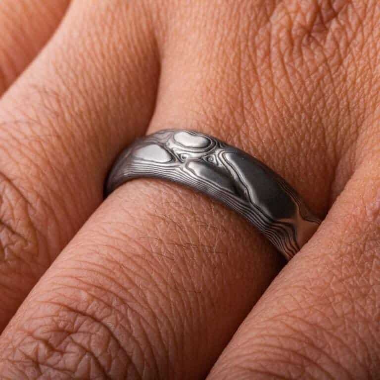 textured mokume ring made to look like rock formation, overall dark gray palette