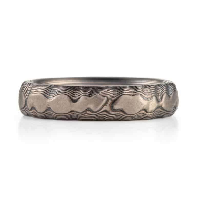 textured mokume ring made to look like rock formation, overall dark gray palette