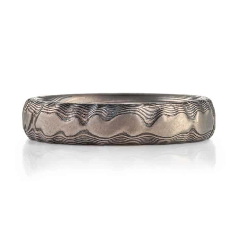 textured mokume ring made to look like rock formation, overall dark gray palette