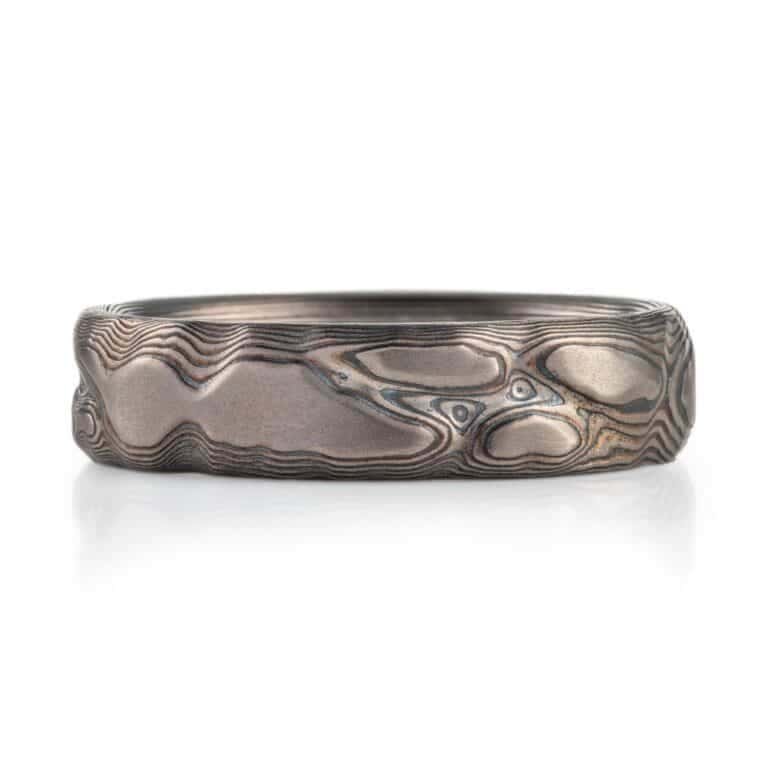 textured mokume ring made to look like rock formation, overall dark gray palette