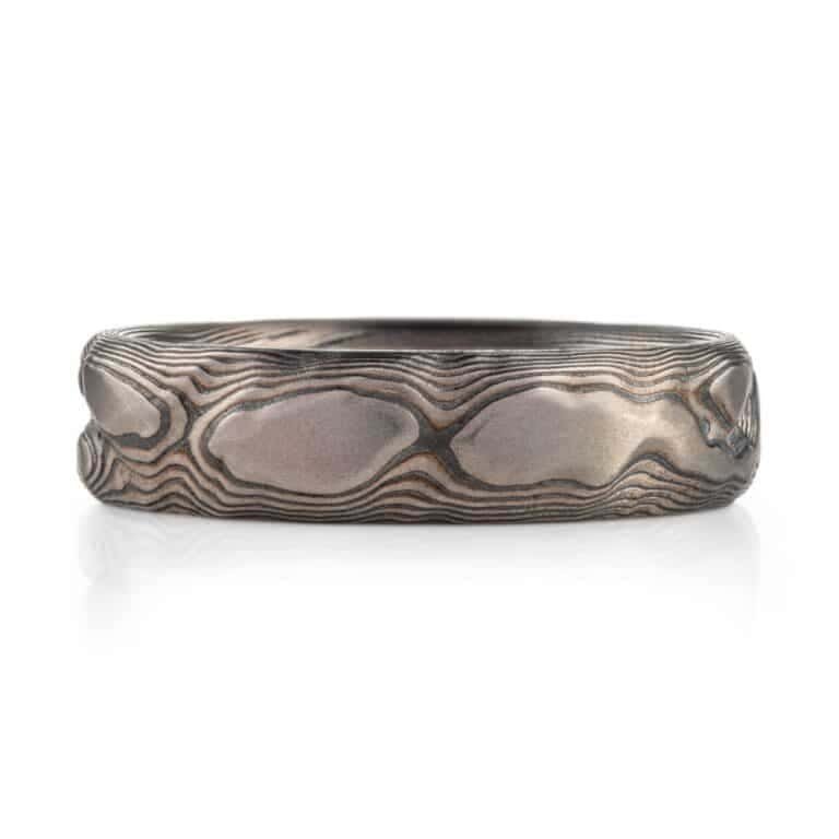 textured mokume ring made to look like rock formation, overall dark gray palette