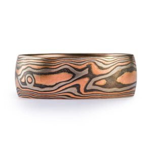 Woodgrain pattern mokume band made with red gold, palladium (gray) and oxidized silver (black).