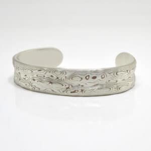 15mm sterling silver and copper bracelet patterned in Guri Bori style, with topographic-like relief for a unique tactile beauty.