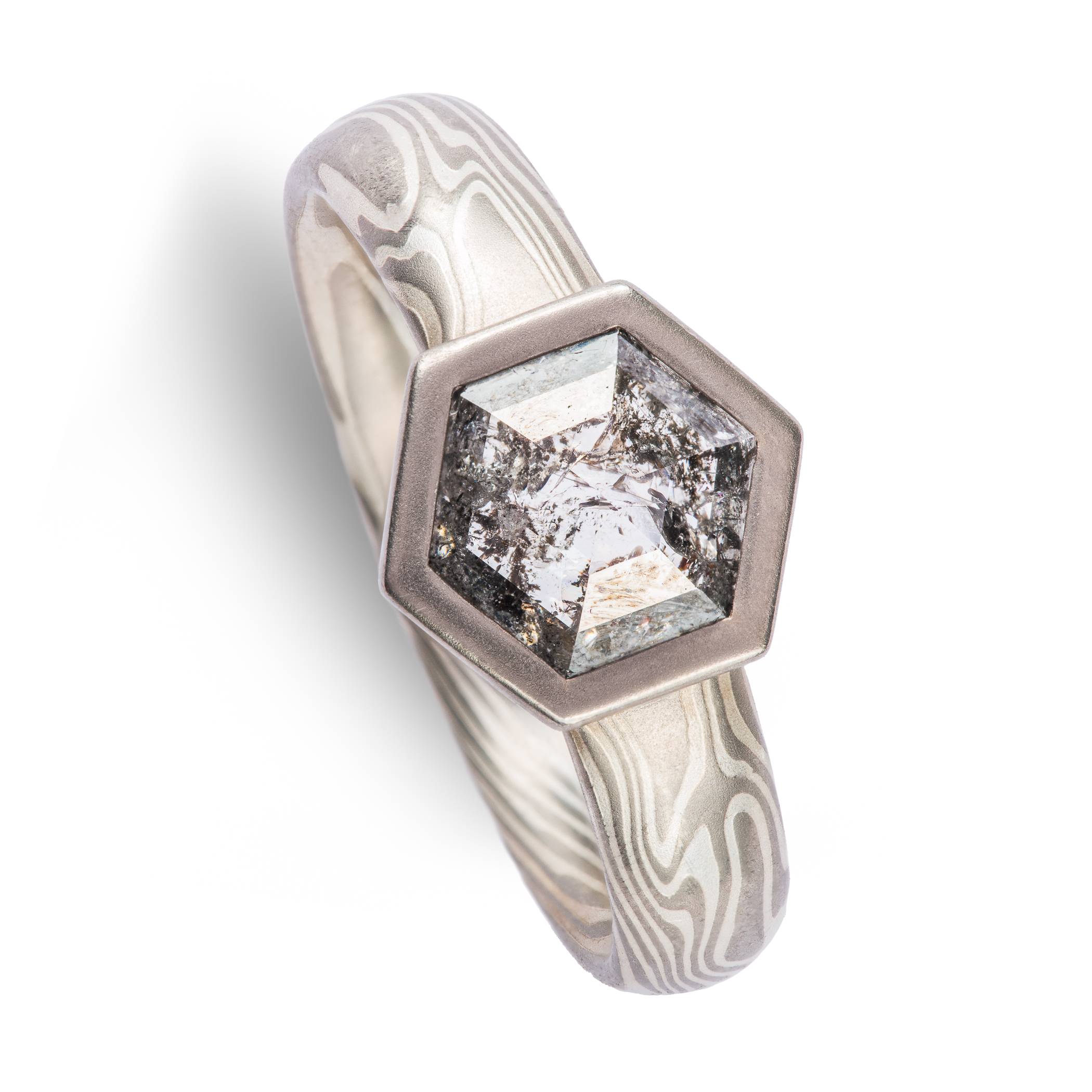 salt and pepper diamond in hexagon cut with hexagon bezel in white gold mokume gane.