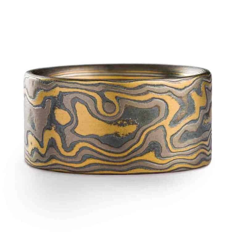 extra wide flat profile mokume gane woodgrain patterned ring, made with yellow gold, palladium and oxidized silver layers